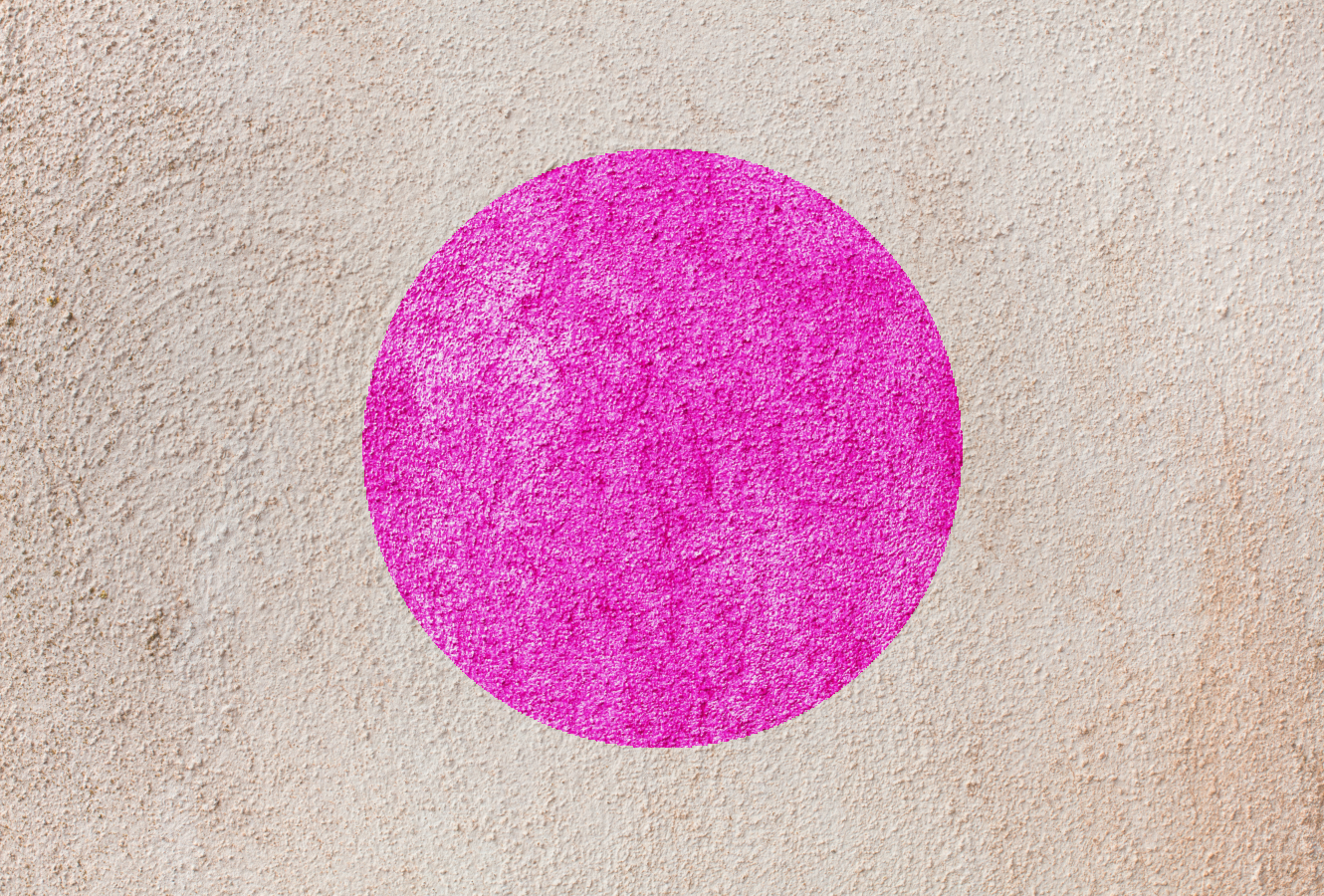 Textured cement wall with pink circle